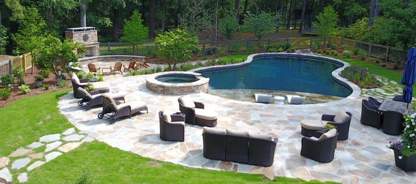 Overhead view of a backyard with pool and fireplace with furniture