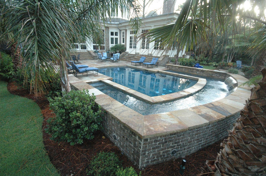 Elevated Aqua Blue Pools Geometric Pool With Outer Waterfall Spill Surrounding Patio