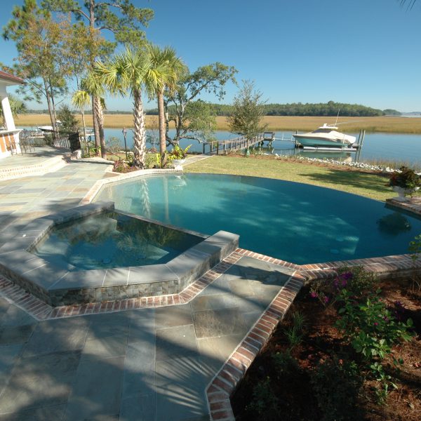 Backyard Curved Infinity Pool with Custom Spa Front View