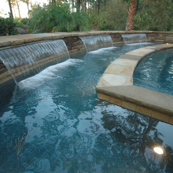 Close up of waterfall surrounding the pool edge