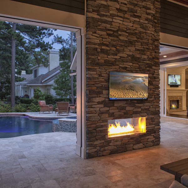 Outdoor living space with pool and patio with tv and fireplace