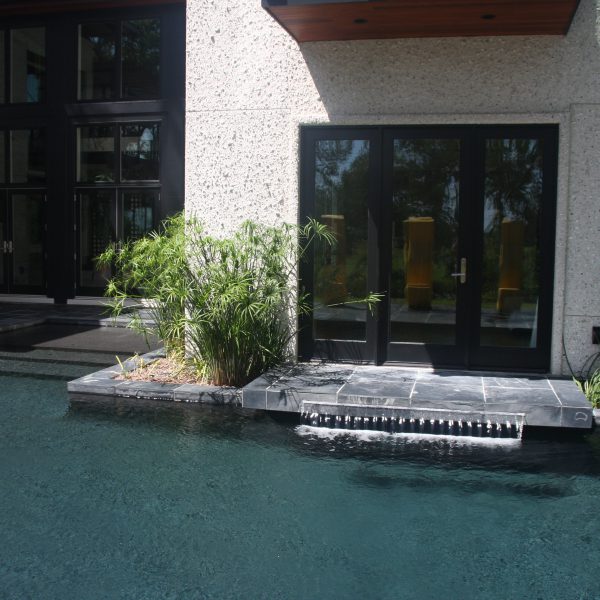 Patio door that leads to outdoor pool and waterfall