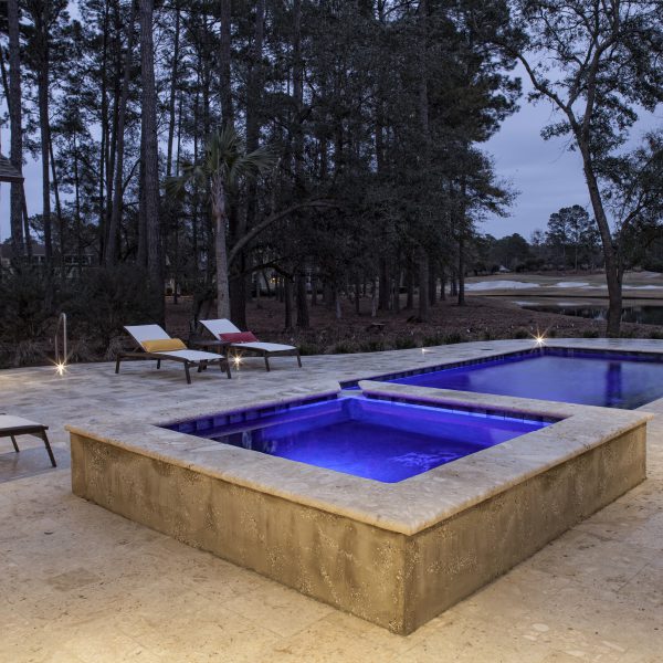 Geometric Pool with Spa at Night with Custom Blue Lighting