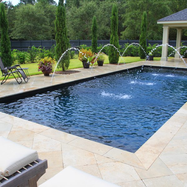 Backyard pool with multiple fountain features