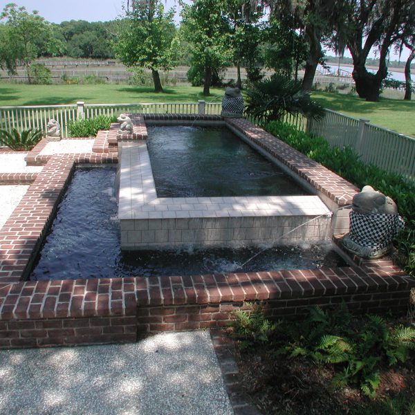 Two water feature ponds with fountains in backyard