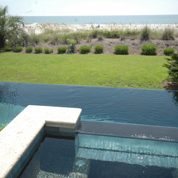 Infinity pool overlooking beach dunes and ocean