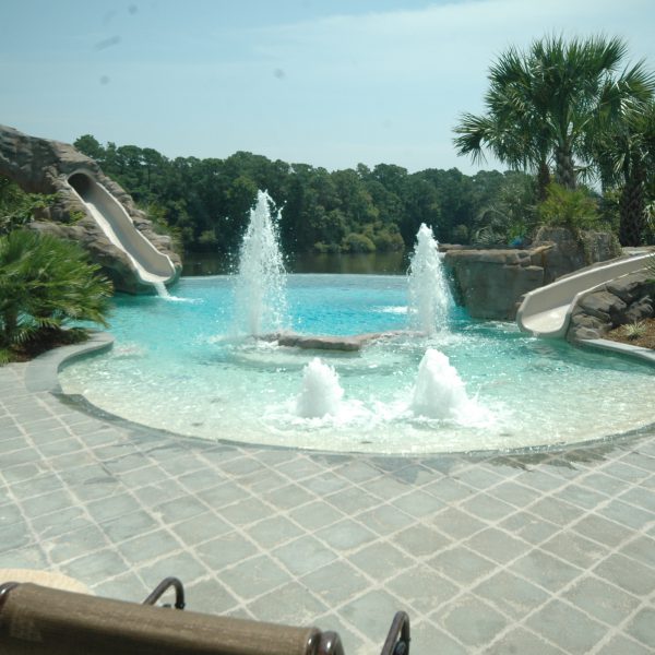 Outdoor pool with four fountains and two water slides