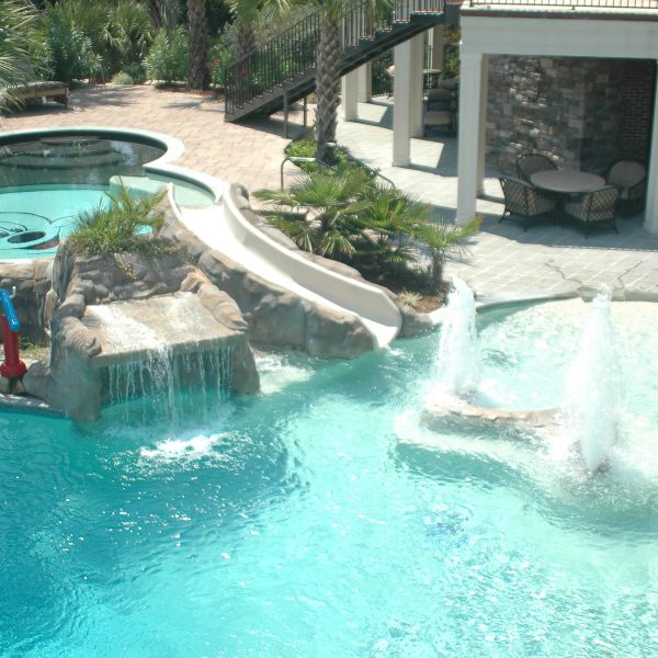 Outdoor pool with fountain and waterfall
