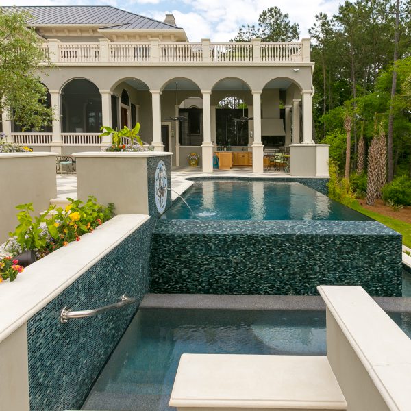 Custom Spa at the back of an Infinity Pool with mosaic tiles