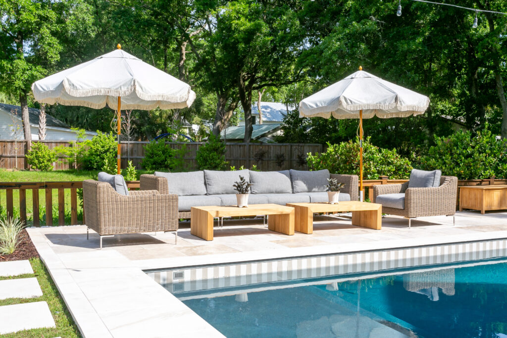 Fancy backyard pool with nice lounge furniture and umbrellas