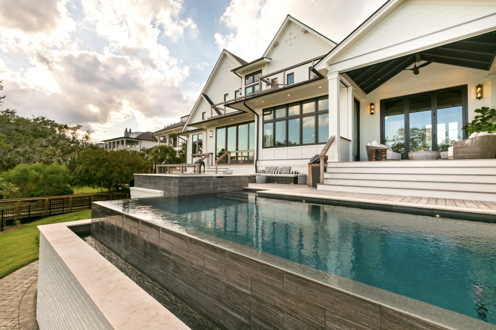 Back of a residential home with an infinity pool