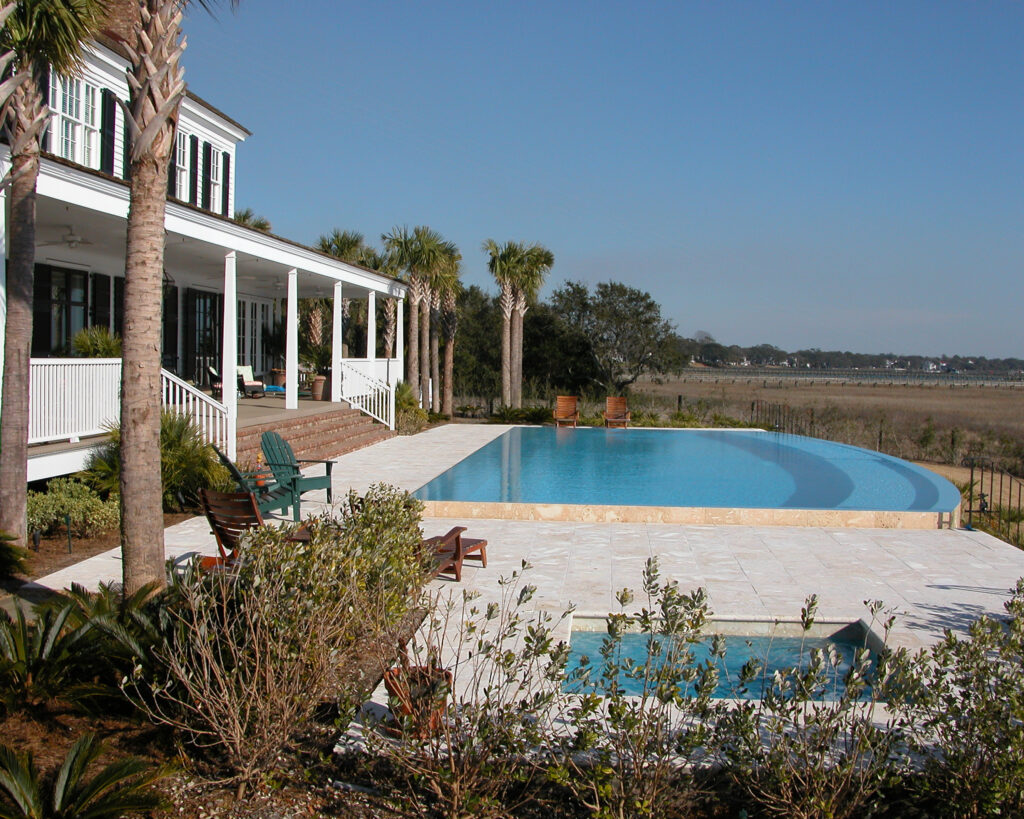 Backyard infinity pool overlooking marsh