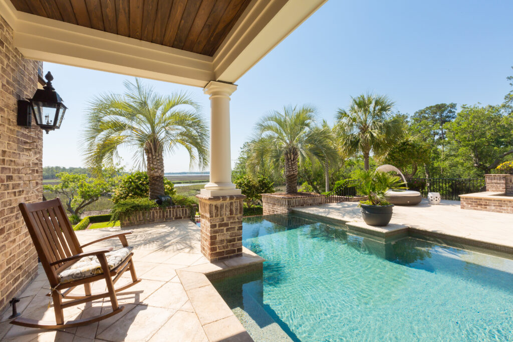 Backyard pool with rocking chair next to it