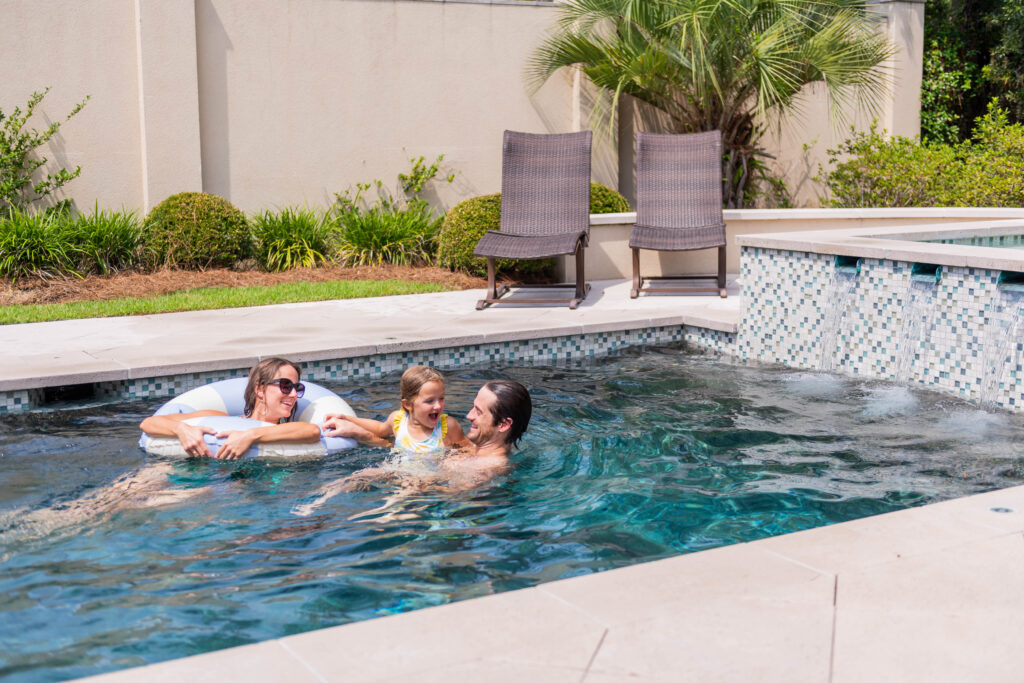 Family swimming and laughing in the pool