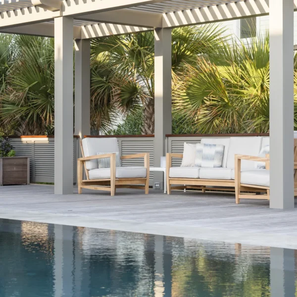 Modern pool deck with a pergola and comfortable outdoor seating.