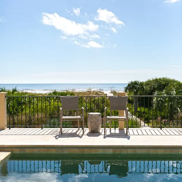 Serene view of the ocean from poolside seating with unobstructed coastal horizon.