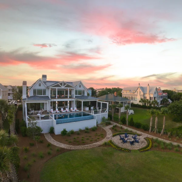 Oceanfront luxury home with infinity pool and sunset sky