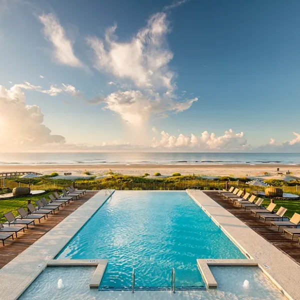Beachfront pool with ocean view and palm-lined deck