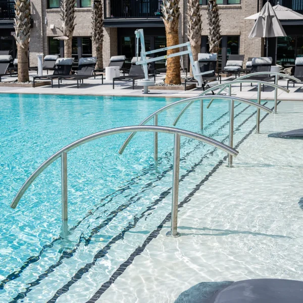 Luxury rooftop pool with loungers and ADA-compliant handrails
