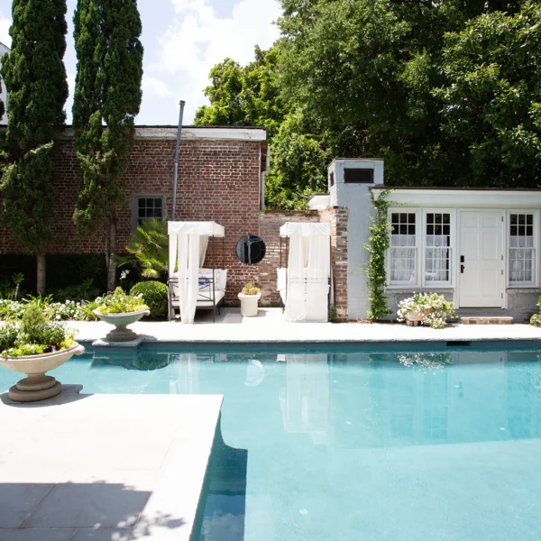 Backyard swimming pool with elegant landscaping and outdoor lounge area.