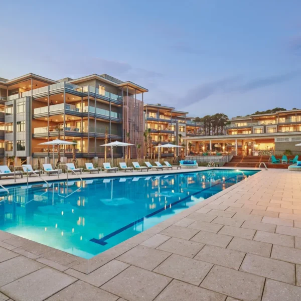 Luxury resort pool with modern architecture at sunset